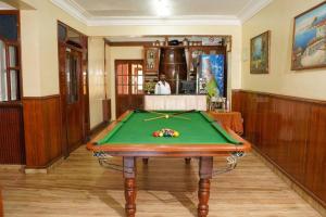 a pool table in the middle of a room at Osborne Holiday Resorts in Calangute