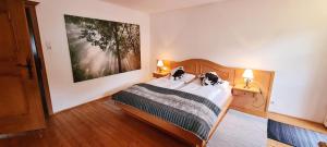 a bedroom with a bed with two dogs on it at Villa Alpenblick in Kitzbühel