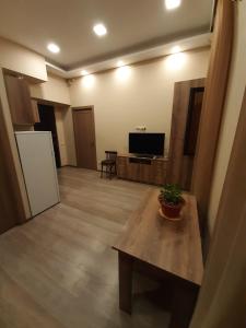 a living room with a table and a tv at Yerevan, Abovyan 34 My street in Yerevan +5 photos