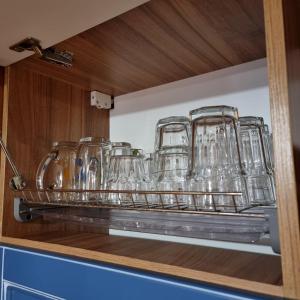 a shelf with glasses on it in a kitchen at Guest House Viktoria&Vladimir in Novyy Svet