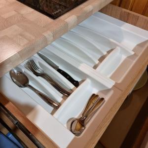 a drawer with silver utensils in a cabinet at Guest House Viktoria&Vladimir in Novyy Svet