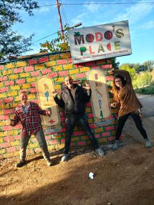 a group of men standing in front of a brick wall at Modos place in Luxor