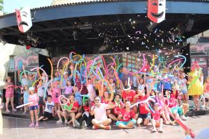 a group of children posing in front of a wall with confetti at Lykia Botanika Beach Fun & Club - All Inclusive in Fethiye