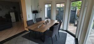 a wooden table and chairs in a living room at Ferienwohnung Flensfjord in Wees
