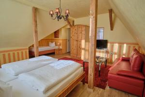 a bedroom with a bed and a chair and a desk at Anno 1900 Hotel Babelsberg in Potsdam