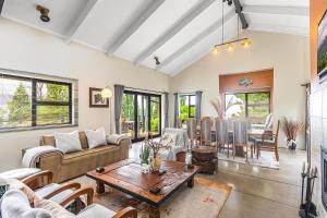a living room with a couch and a table at Rhino Retreat Clarens in Clarens