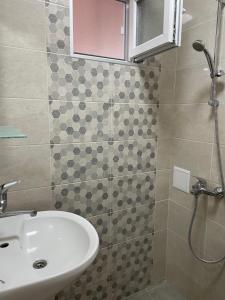 a bathroom with a sink and a shower at Lux Apart Uzunov-2 in Hisarya