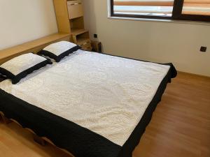 a bedroom with a large bed in a room at Lux Apart Uzunov-2 in Hisarya