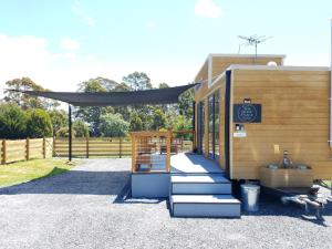 a tiny house sitting on top of a gravel lot at Tiny Cradle at The Good Place in Staverton