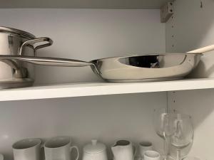 a kitchen shelf with a sink and cups on it at Gare-30A-3 in Lausanne