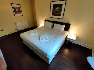 a bedroom with a large bed with two trays on it at Tron Kirk Residence in Edinburgh