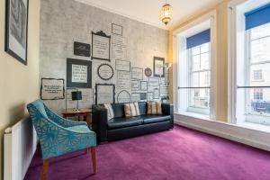 a living room with a couch and a chair at Tron Kirk Residence in Edinburgh