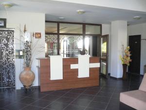 a lobby with a pharmacy with a cross on the wall at Madara Club and Spa in Kosharitsa +34 photos