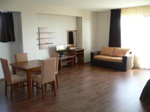 a living room with a table and a couch at Madara Club and Spa in Kosharitsa