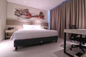Postel nebo postele na pokoji v ubytování Prime Park Hotel & Convention Lombok