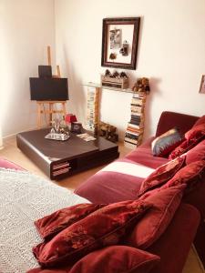 a living room with two beds and a table at La Romanée in Sallaumines