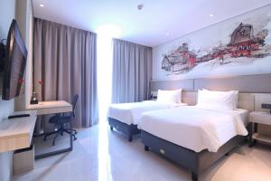 Postel nebo postele na pokoji v ubytování Prime Park Hotel & Convention Lombok