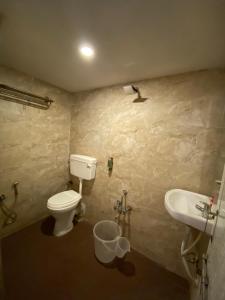 a bathroom with a toilet and a sink at Hotel Riverfront in Ahmedabad