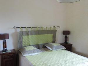 a bedroom with a bed with two night stands and two lamps at Villa Roland en Bourgogne in Chagny