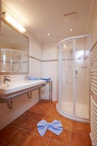 a bathroom with a shower and a sink at Sportpension Alpenrose in Schladming