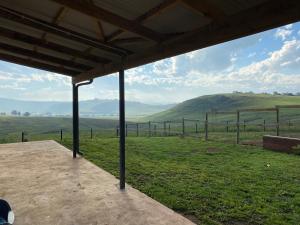 a view of the rolling hills from a farm pavilion at Twin peaks in Underberg