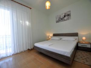 Posteľ alebo postele v izbe v ubytovaní House Karlo Apartments