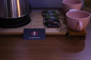 a table with a tea cup on a cutting board at lily airport otel in Arnavutköy