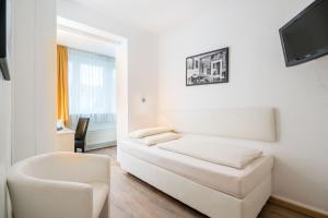 Ein Bett oder Betten in einem Zimmer der Unterkunft Stadt-gut-Hotel Rheinischer Hof