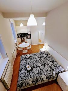a bedroom with a bed with a black and white blanket at Monza Apartments in Monza