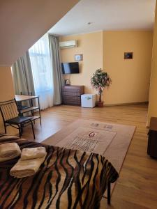 a bedroom with a zebra print bed and a living room at Vodnyi Mir in Bilhorod-Dnistrovsʼkyy