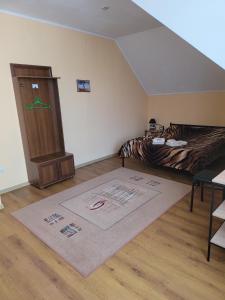 a bedroom with a bed and a rug on the floor at Vodnyi Mir in Bilhorod-Dnistrovsʼkyy