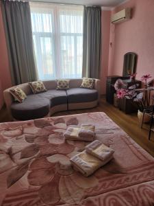 a living room with a couch and a large bed at Vodnyi Mir in Bilhorod-Dnistrovskyi