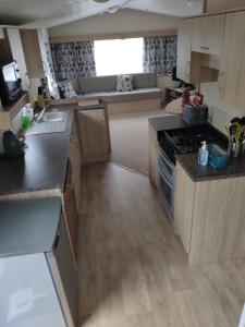 a kitchen with a stove top oven in a room at Lovely Static 8 Bed Caravanat at Billing Aquadrome in Great Billing