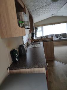a small kitchen with a counter top in a caravan at Lovely Static 8 Bed Caravanat at Billing Aquadrome in Great Billing