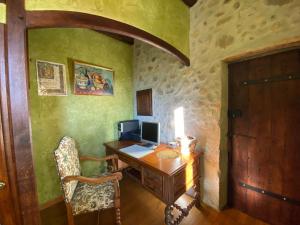 an office with a desk with a computer on it at La Maison d'Euterpe in Sainte-Marie-dʼAlloix