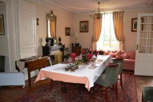 a living room with a table and a couch at Manoir La Breuille in Montmoreau