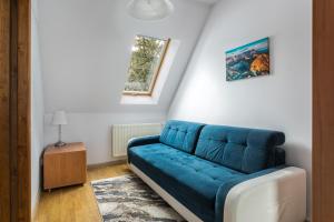 a blue couch sitting in a living room at Rent like home - Arkadia pod Nosalem in Zakopane