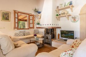 a living room with couches and a fireplace at Ca na Miracles in Pollença