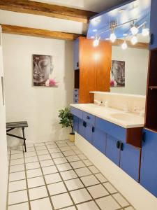 a bathroom with blue cabinets and a sink at aday - Aalborg Mansion - Charming 3 Bedroom Apartment in Aalborg
