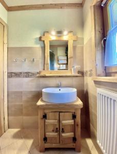 a bathroom with a sink and a mirror at Domek Góralski- Highlander Chalet Kościelisko-Zakopane in Kościelisko