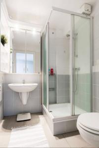 a bathroom with a shower and a sink and a toilet at Penthouse -By the Danube in Budapest
