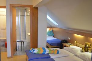 a small room with two beds and a bathroom at Apartment Mauser-Mühltaler in Mauterndorf