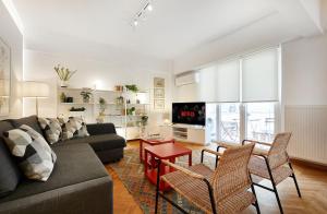 a living room with a couch and a table at Chloe Boutique Apartments Nikis in Athens
