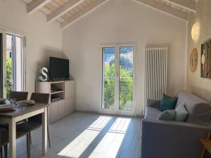 a living room with a couch and a table at La Mia Casa A Finalborgo in Finale Ligure