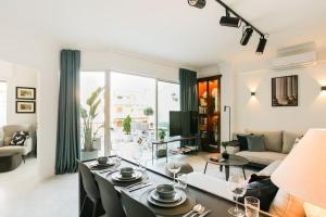 a living room with a table and a couch at Acropolis Veranda Residence in Athens