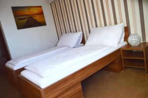 Posteľ alebo postele v izbe v ubytovaní Penzión Hoffer
