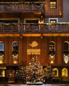 a building with a christmas tree in front of it at Airelles Val d'Isère in Val-d'Isère