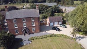 an aerial view of a house with a car parked in front at Blackgreaves Farmhouse in Lea Marston