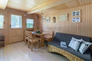 a living room with a couch and a table at Chalet Encijan - Velika planina in Stahovica
