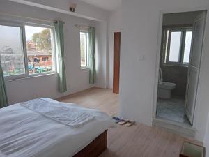 Postel nebo postele na pokoji v ubytování Eco Inn Guest House